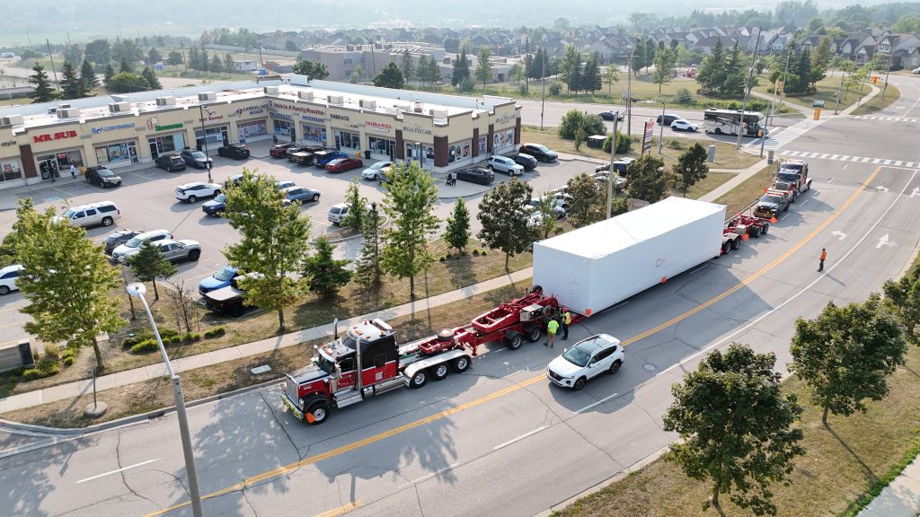 Scott-Woods heavy haul truck transporting a large modular load using specialized trailer equipment and escort support. showcasing our heavy haul fleet.