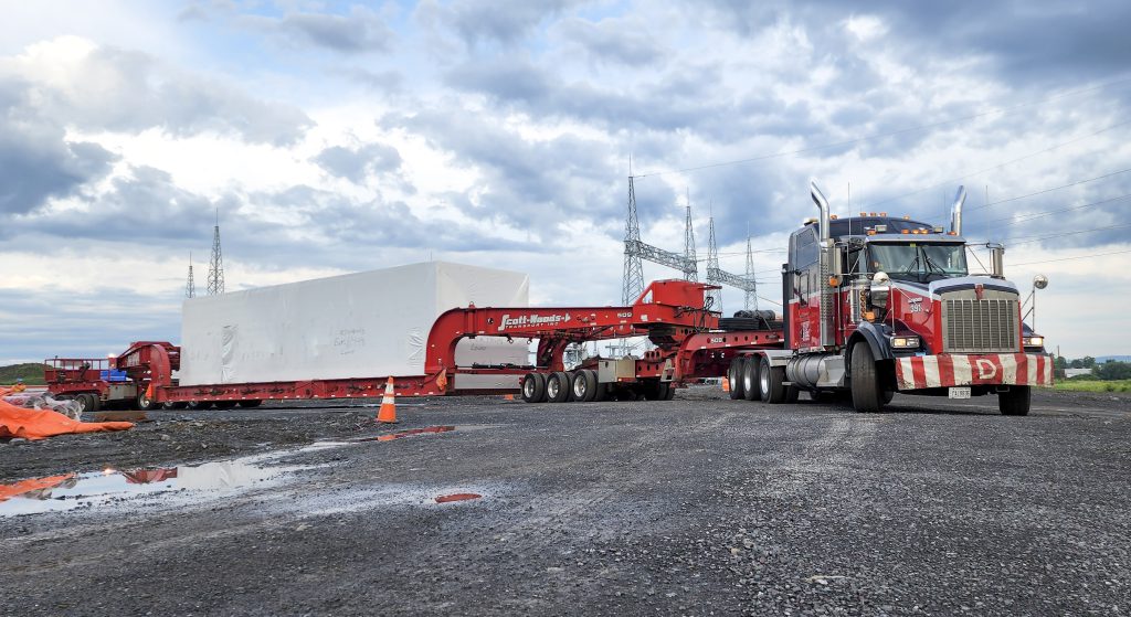 Heavy haul truck transporting a large over-dimensional load using advanced trailer configurations and specialized equipment.