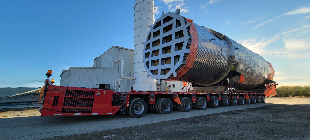 Scott-Woods Goldhofer SPMT transporting an oversized industrial vessel using specialized heavy haul equipment.