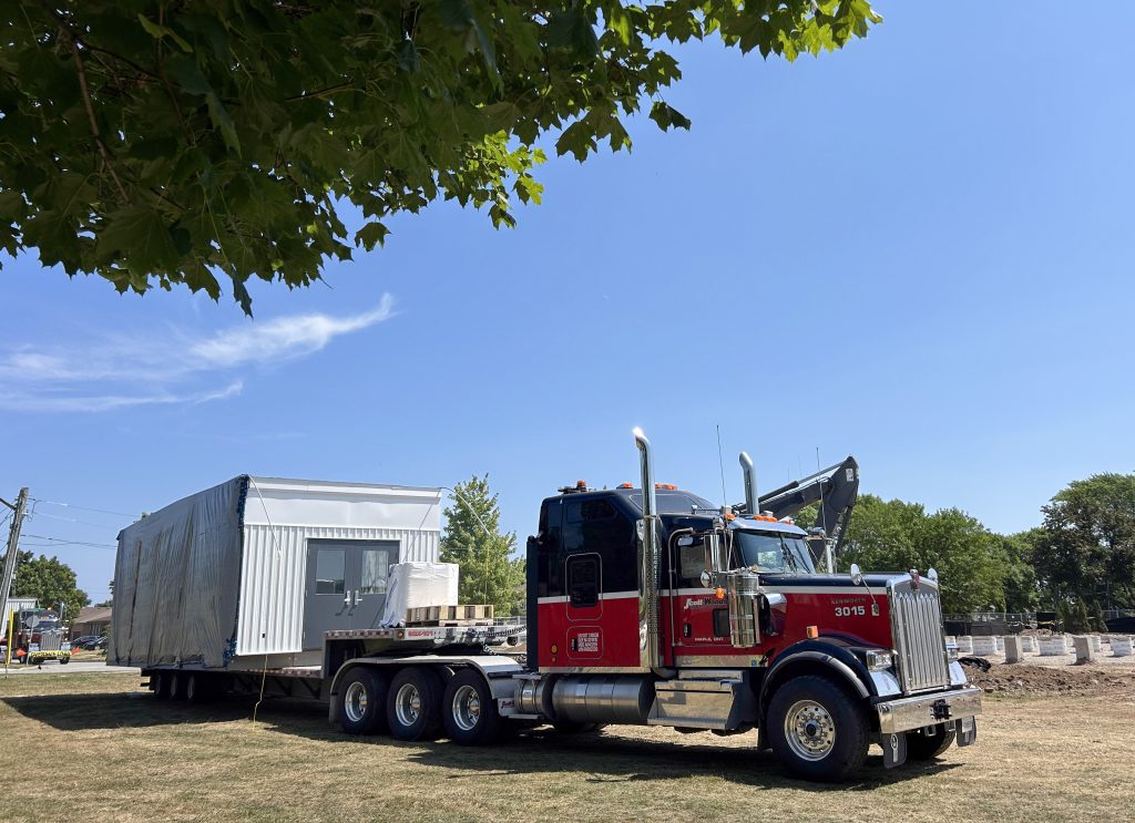 Scott-Woods transporting and installing modular portable classrooms using specialized heavy haul equipment.