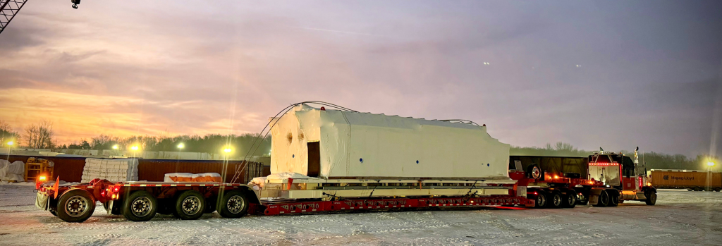 Scott-Woods heavy haul trucking transporting oversized modular equipment during spring thaw season. Oversized modular transportation using hydraulic heavy haul trailer configuration.